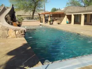 Backyard pool & spa with automatic pool covers.
